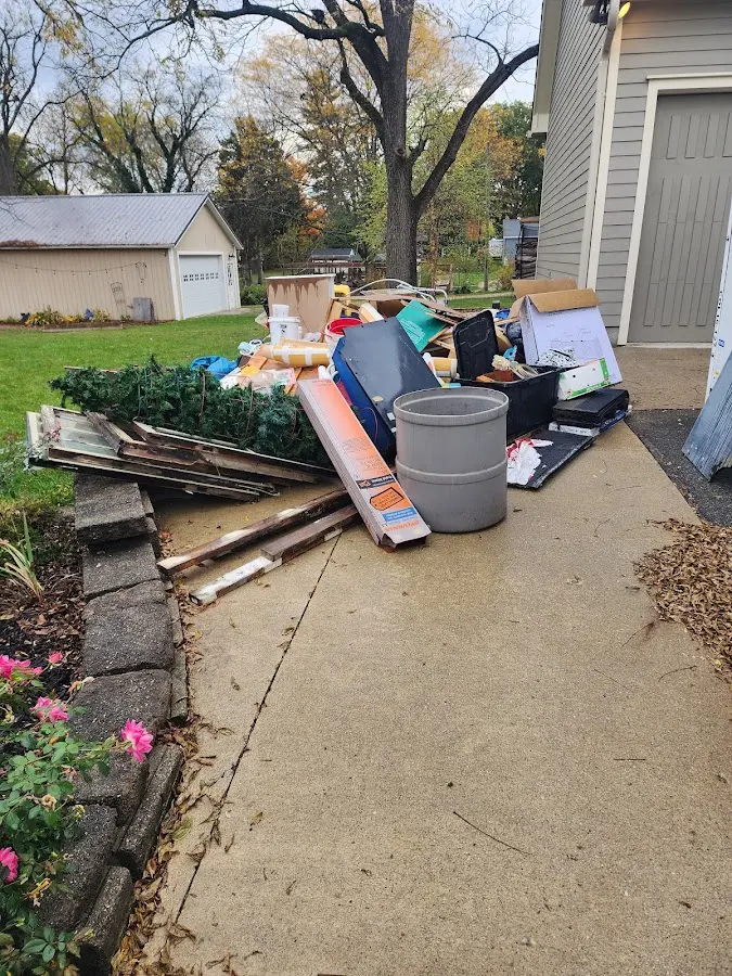 Dumpster being loaded with debris for Residential Dumpster Rental in Rollingwood